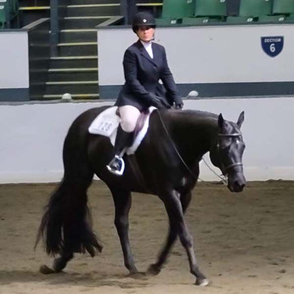 Audra and her horse competing