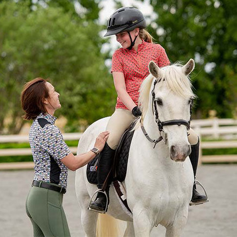 Woman talking to child on horseback Woman talking to child on horseback